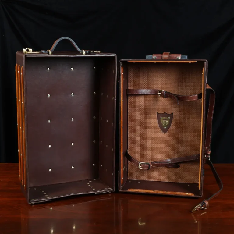 no 3 travel trunk in american buffalo - showing it open with a dark background on wood table