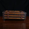 no 3 travel trunk in american buffalo - showing the side with a dark background on wood table