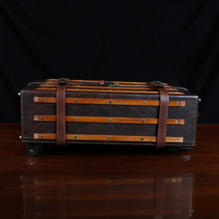 no 3 travel trunk in american buffalo - showing the side with a dark background on wood table