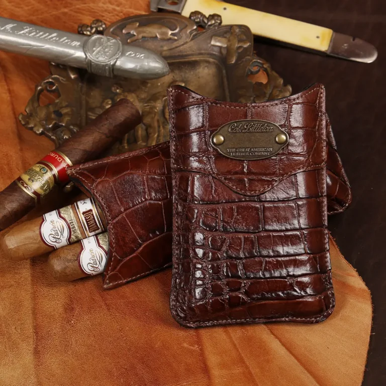 A leather Cigar Case in American Alligator showing the front with brass hardware.