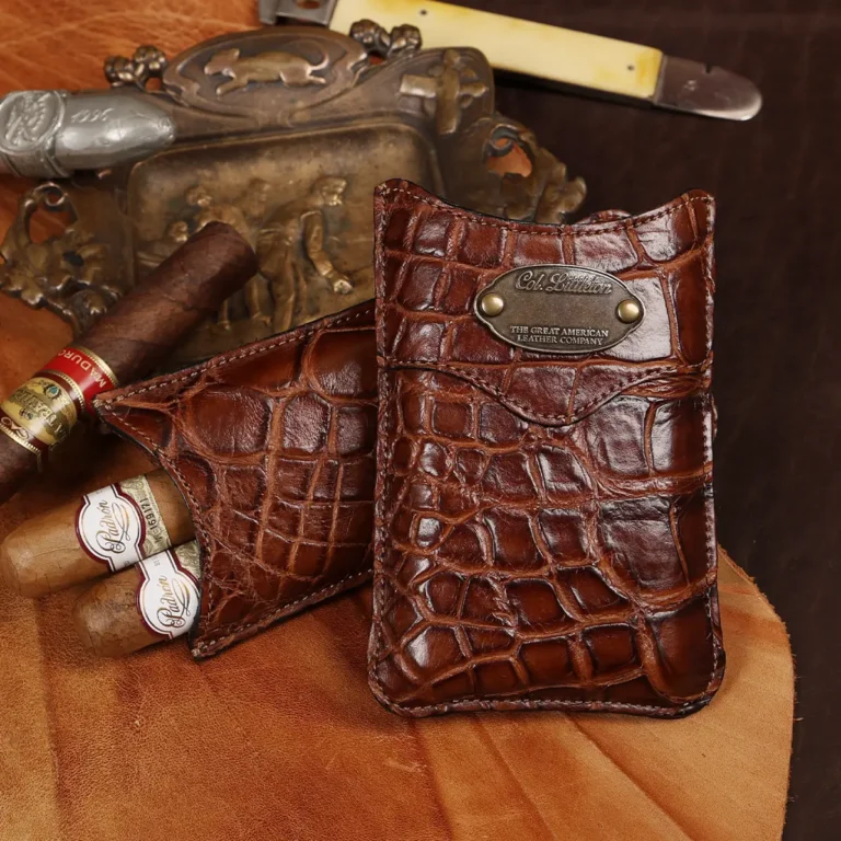 A leather Cigar Case in American Alligator showing the front with brass hardware.