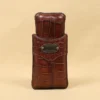A leather Cigar Case in American Alligator showing the front with brass hardware - id 001