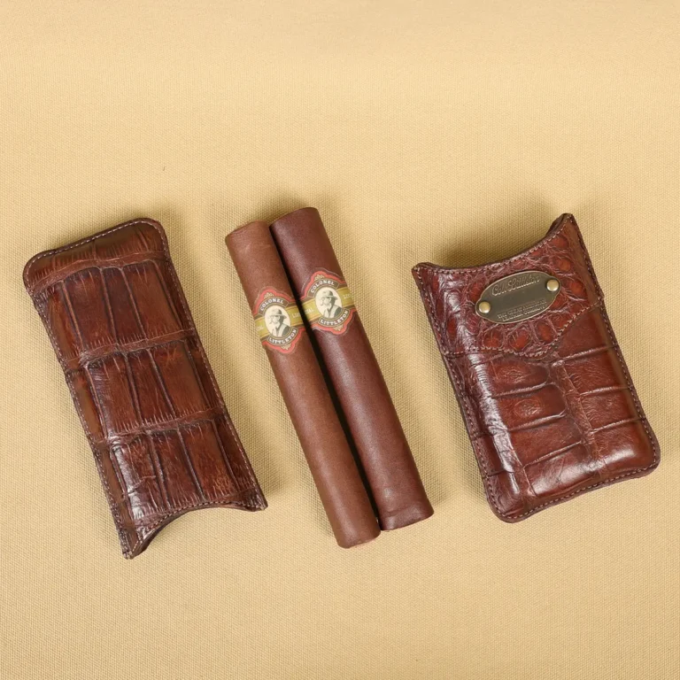 A leather Cigar Case in American Alligator showing the front and leather cigars with brass hardware - id 001
