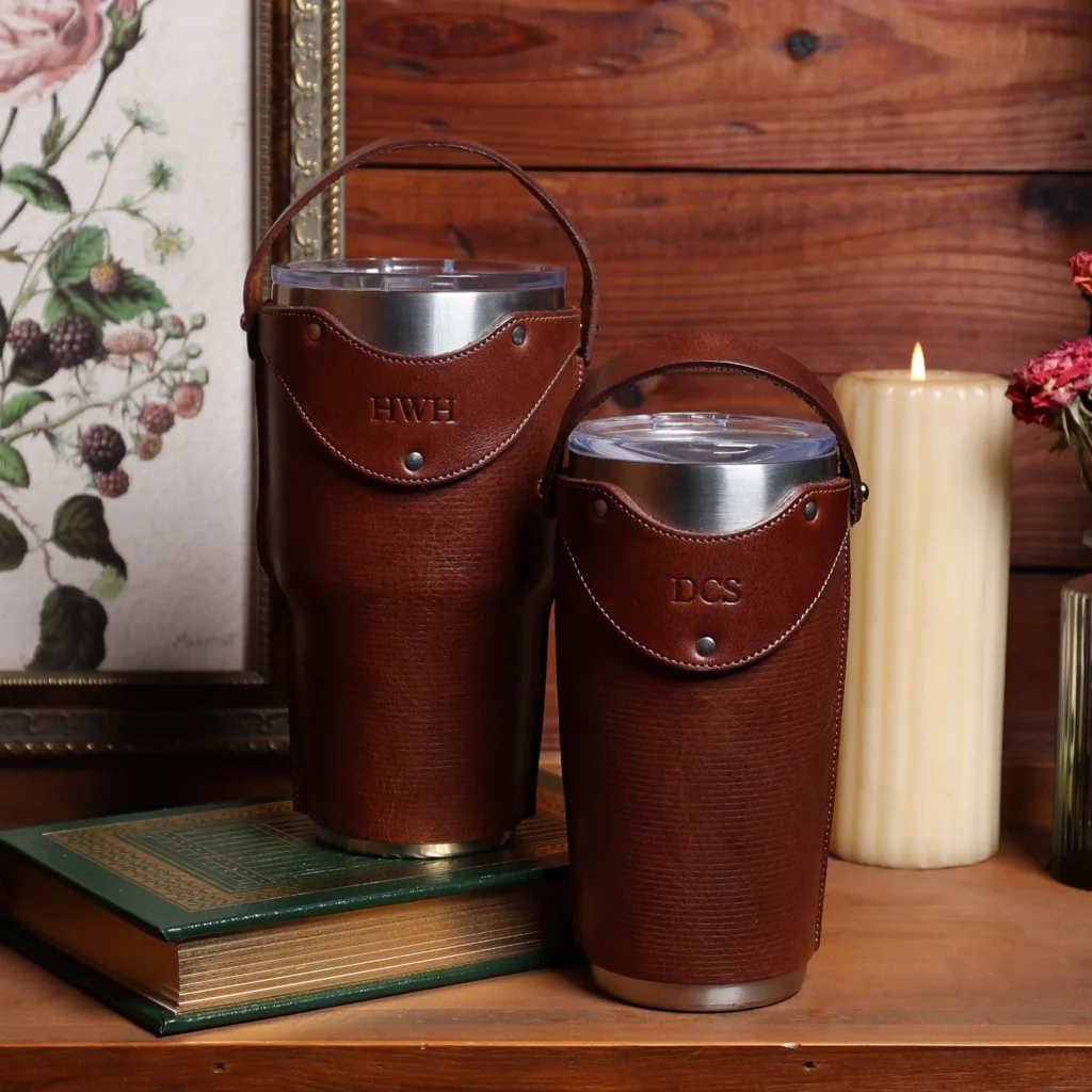 Two of the American steerhide leather tumbler sets, in front of a vintage valentine setting.