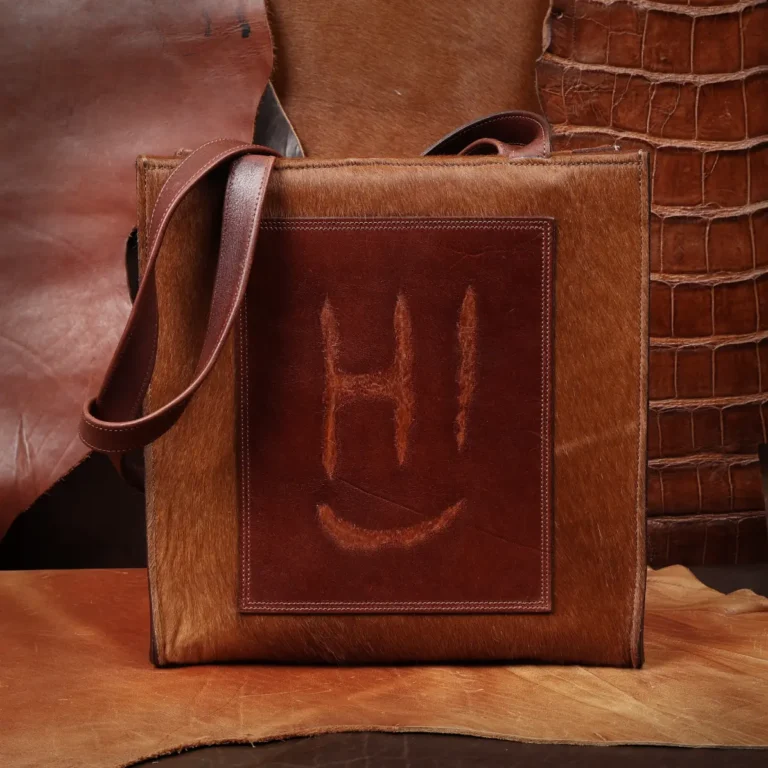 front side of the hair on hide tote with a branded patch