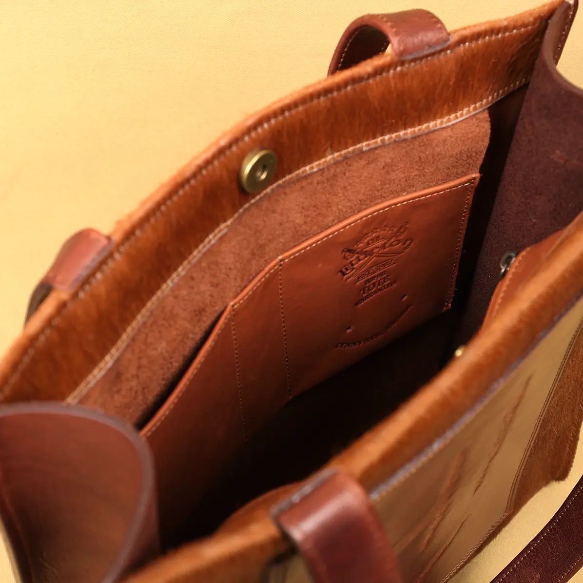 View larger image of open view of the hair on hide tote with a branded patch