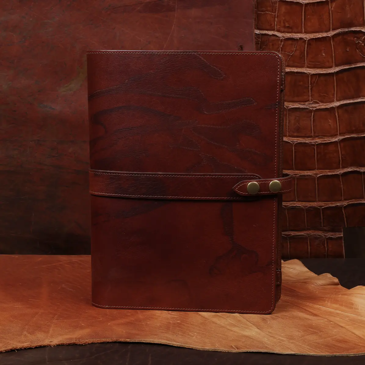View larger image of Rugged leather portfolio showing the front with brass hardware.