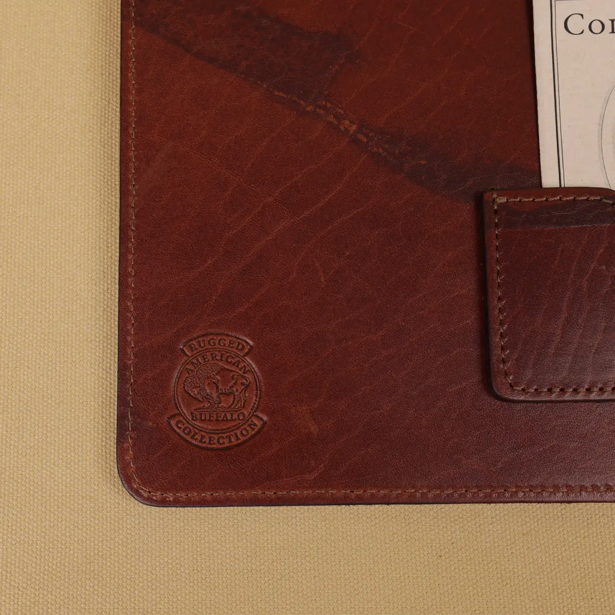 View larger image of Rugged leather portfolio showing the front with brass hardware.