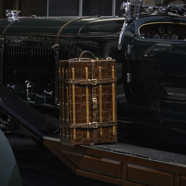 the American Alligator trunk sitting on the sidebar of a classic bentley