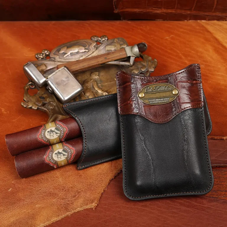 The back side of a Black American Steerhide and American Alligator trim leather cigar case with brass hardware.