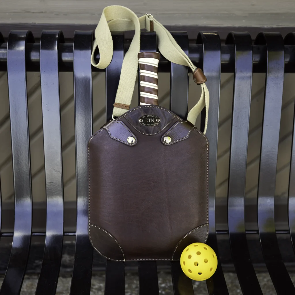 leather pickleball paddle on bench