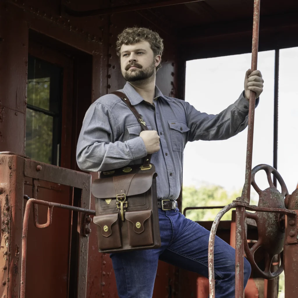 Man on train with the No. 20 dispatch bag