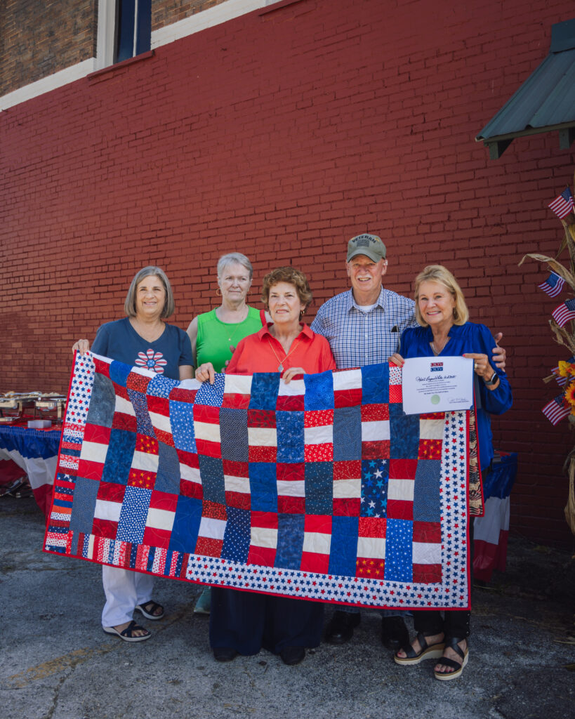 The Cumberland Valley Quilters present Sgt. Robert White with a quilt to honor his military service.